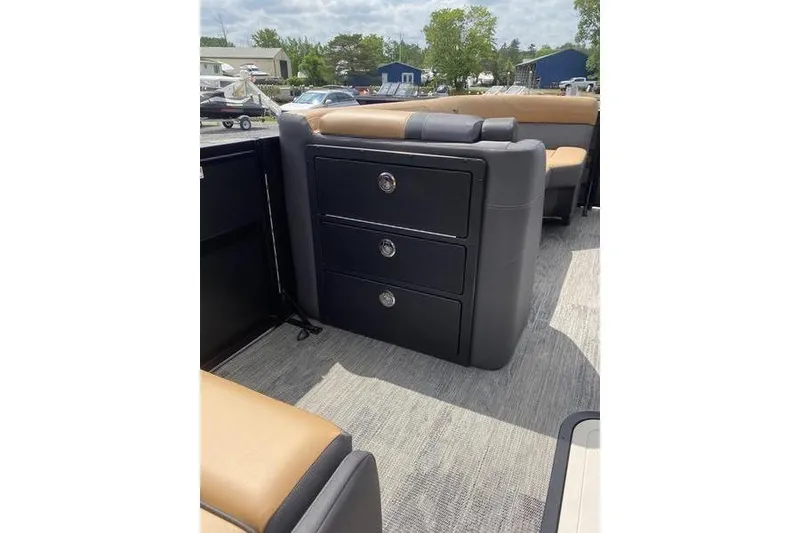 Slide: The Image of 2025 Viaggio Lago Z-S boat interior with black storage drawers and tan seating. - 24