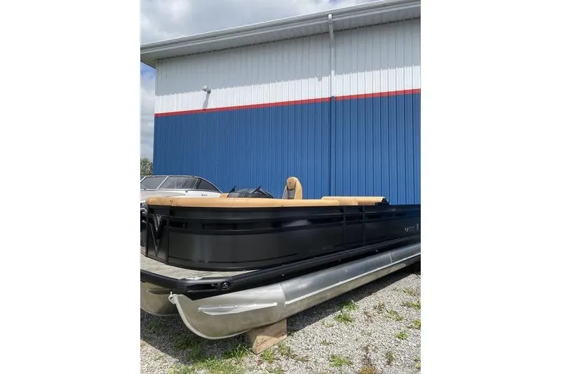 Slide: The Image of 2025 Viaggio Lago Z-S pontoon boat parked outdoors near a blue building. - 3