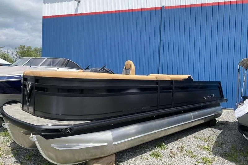 Slide: The Image of 2025 Viaggio Lago Z-S pontoon boat with sleek black design, parked outdoors. - 5