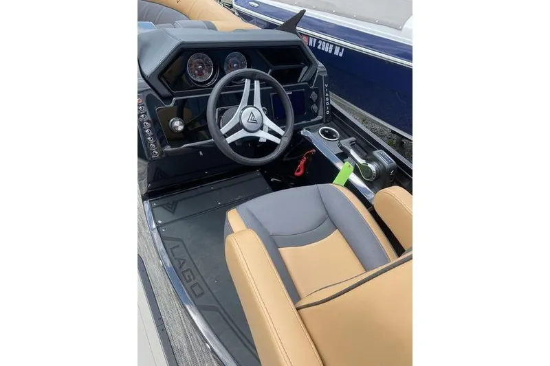 Slide: The Image of 2025 Viaggio Lago Z-S boat interior with steering wheel and tan seating. - 8