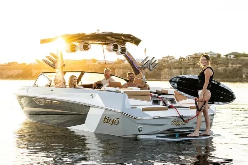 Slide: The Image of Manufacturer Provided Image: 2024 Tigé Ultré 25ZX boat with people enjoying water activities at sunset. - 11
