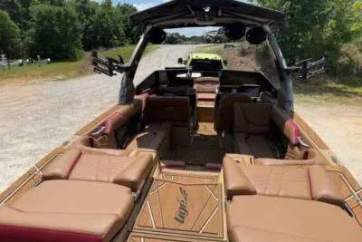 Slide: The Image of 2024 Tigé Ultré 25ZX boat with luxurious seating and modern design on a sunny day. - 5