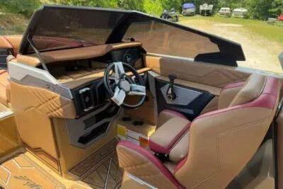 Slide: The Image of 2024 Tigé Ultré 25ZX boat interior with luxurious seating and modern dashboard design. - 6