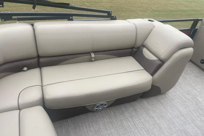 Slide: The Image of 2019 Regency 210 DL3 boat interior with beige seating and speaker. - 11