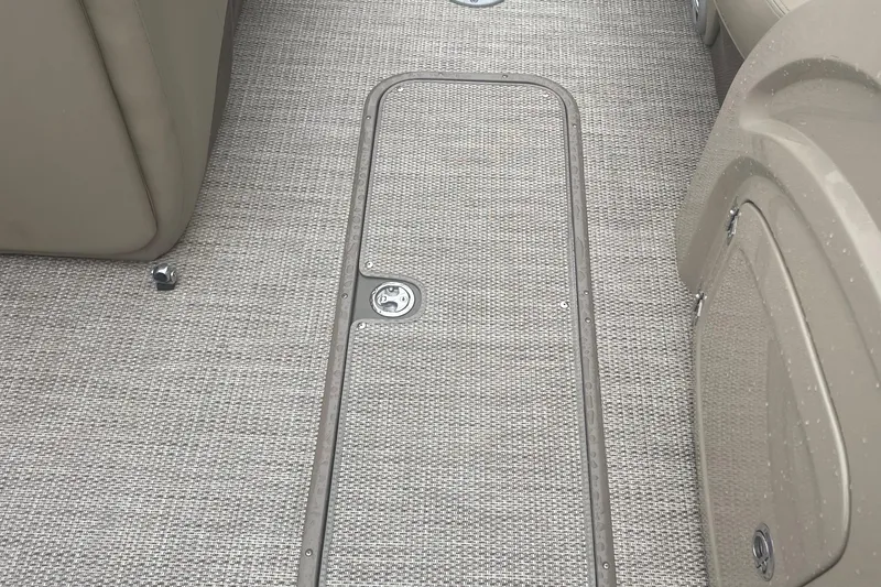 Slide: The Image of 2019 Regency 210 DL3 boat interior with textured flooring and storage compartment. - 12