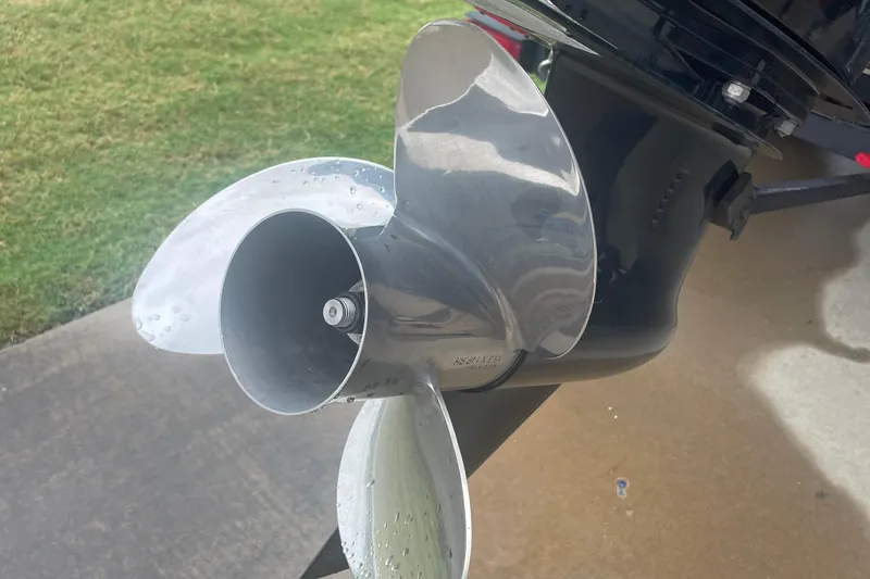Slide: The Image of Close-up of a 2019 Regency 210 DL3 boat propeller with water droplets. - 6