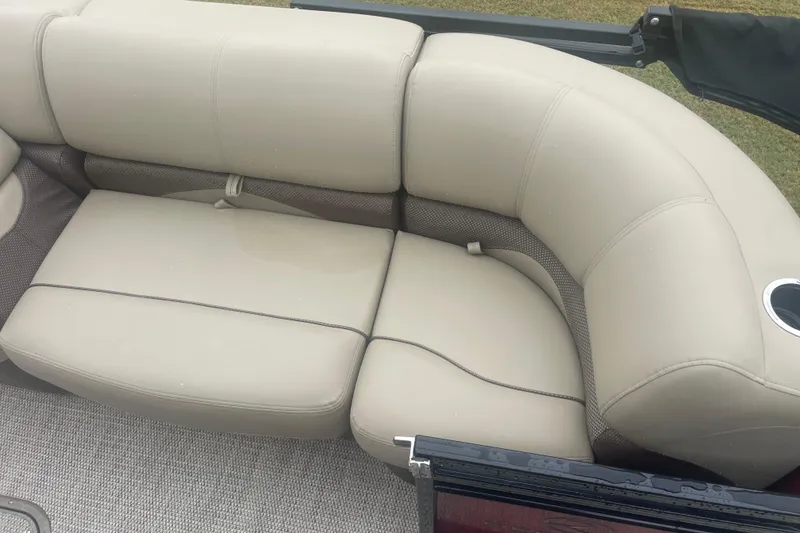 Slide: The Image of 2019 Regency 210 DL3 boat seating with beige upholstery and cup holder. - 8