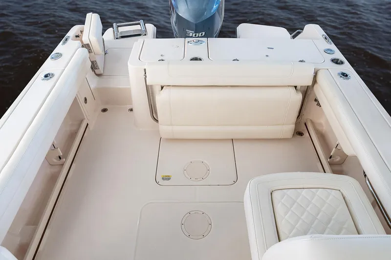 Slide: The Image of 2023 Grady-White Freedom 235 boat interior with beige seating and helm station. - 13