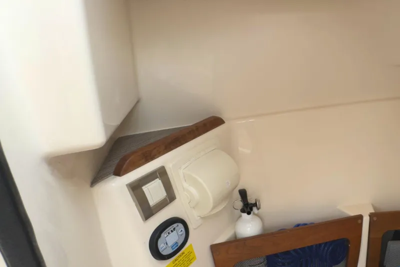 Slide: The Image of 2023 Grady-White Freedom 235 interior detail with control panel and storage area. - 17