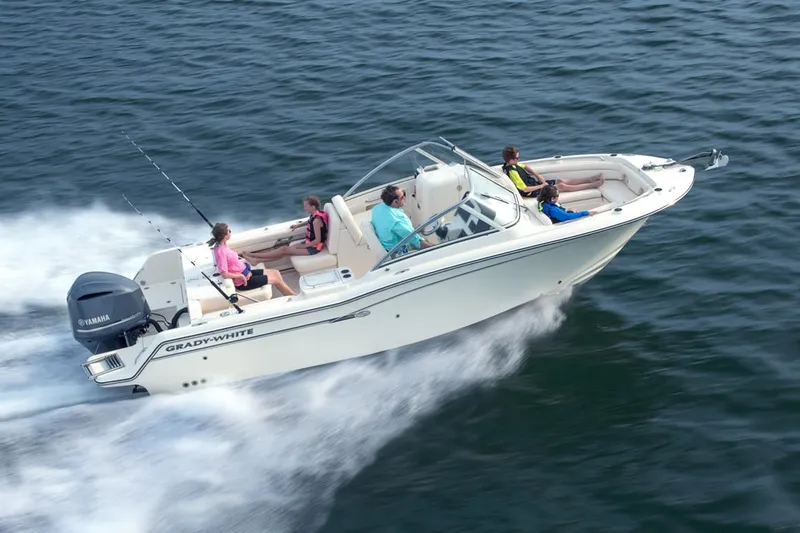 Slide: The Image of 2023 Grady-White Freedom 235 boat cruising on a calm river. - 2