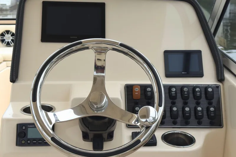 Slide: The Image of Steering console of 2023 Grady-White Freedom 235 boat with control panel and displays. - 20