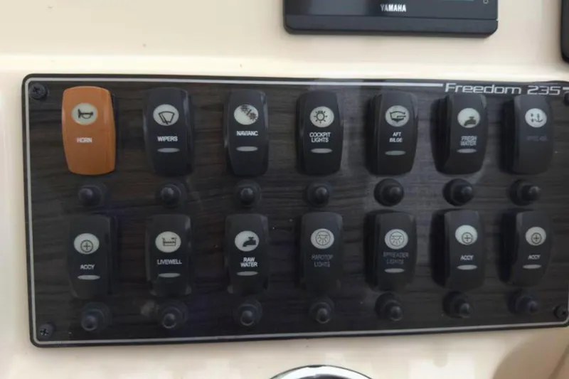 Slide: The Image of Control panel of 2023 Grady-White Freedom 235 boat with labeled switches. - 22