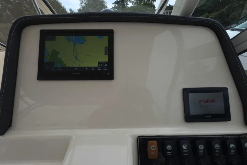 Slide: The Image of Dashboard of 2023 Grady-White Freedom 235 with Garmin and Yamaha displays. - 23