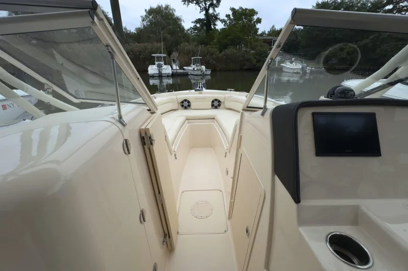 Slide: The Image of 2023 Grady-White Freedom 235 boat interior with seating and control panel. - 25