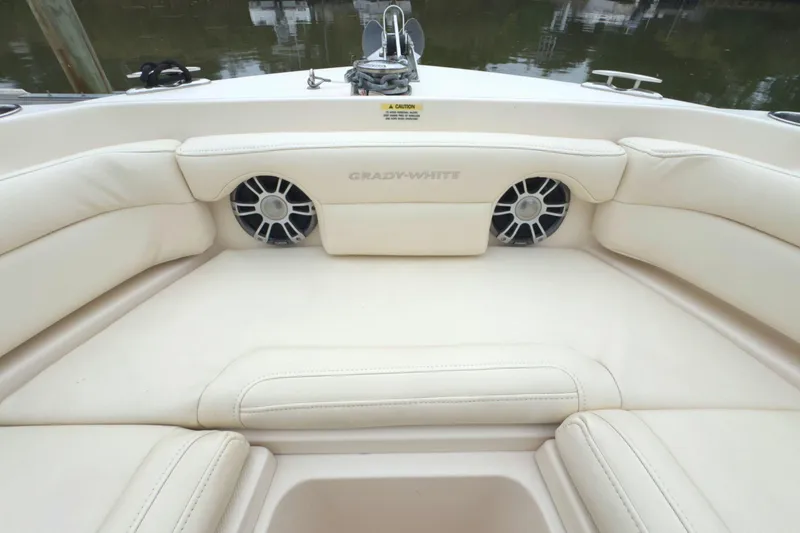 Slide: The Image of 2023 Grady-White Freedom 235 boat interior with cushioned seating and speakers. - 29