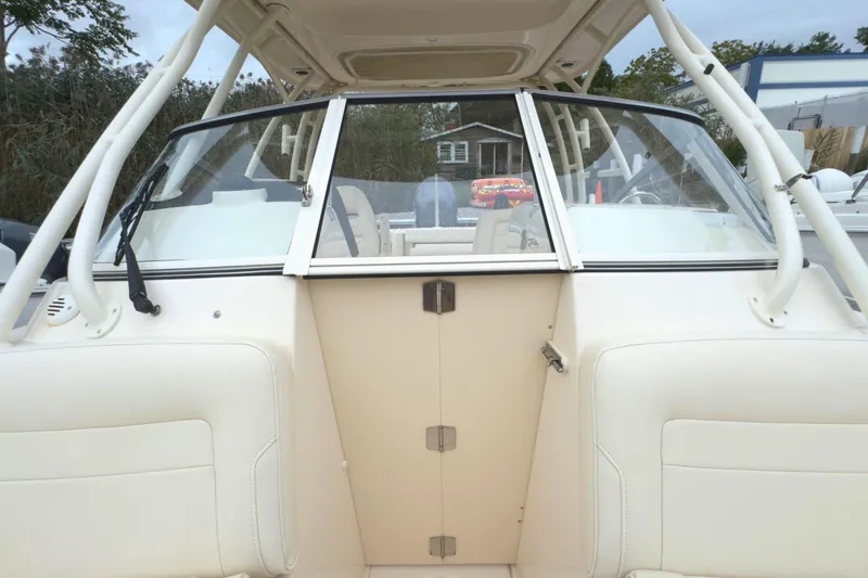 Slide: The Image of 2023 Grady-White Freedom 235 boat interior with windshield and seating. - 32
