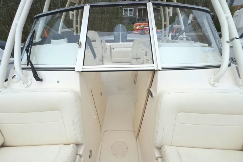 Slide: The Image of 2023 Grady-White Freedom 235 boat interior with beige seating and windshield. - 33