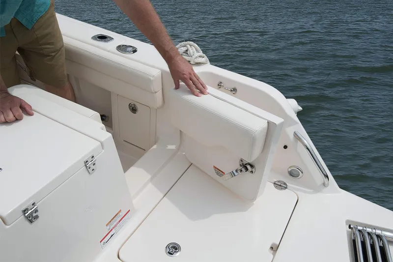 Slide: The Image of 2023 Grady-White Freedom 235 boat cruising on a calm river near lush greenery. - 5