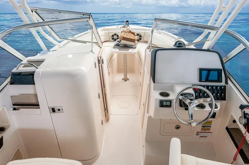 Slide: The Image of 2023 Grady-White Freedom 235 boat interior with beige seating and deck. - 8