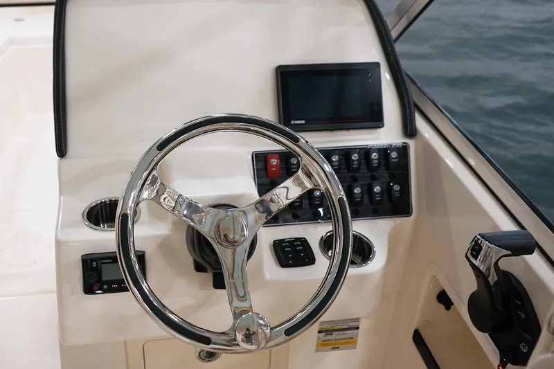Slide: The Image of 2023 Grady-White Freedom 235 boat interior with foldable seating and storage compartments. - 9