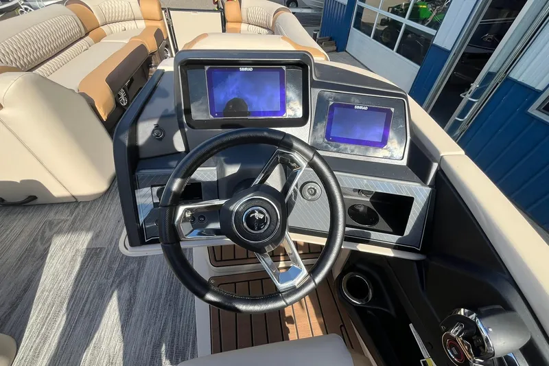 Slide: The Image of 2026 Avalon Catalina Versatile Rear Bench boat dashboard with dual Simrad displays and steering wheel. - 20