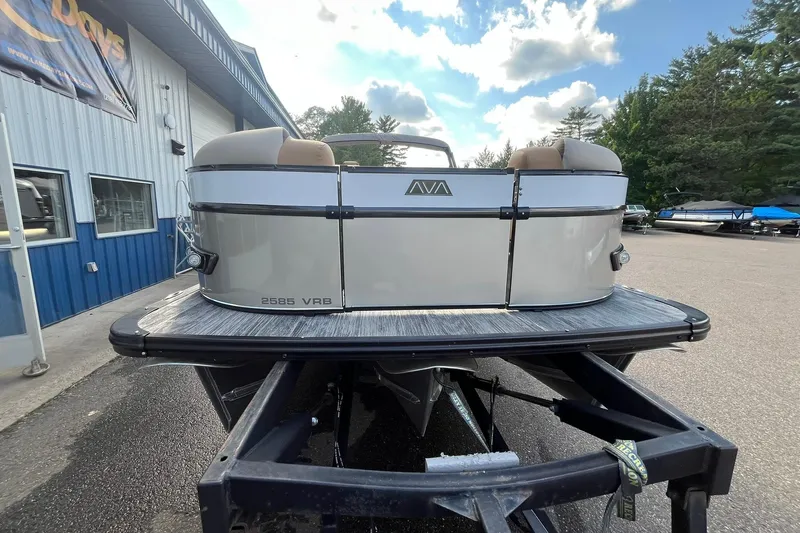 Slide: The Image of 2026 Avalon Catalina Versatile Rear Bench pontoon boat on trailer, outdoor setting. - 6