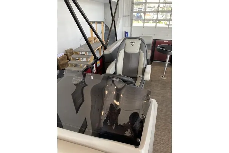 Slide: The Image of Captain's chair and console of 2025 Viaggio Lago V-U boat in showroom setting. - 21