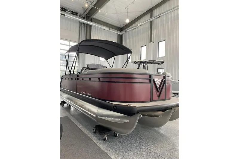 Slide: The Image of 2025 Viaggio Lago V-U pontoon boat in showroom, featuring sleek design and canopy. - 7