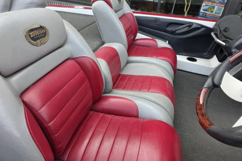 Slide: The Image of 2006 Triton Tr-21X HP DC boat interior with red and gray leather seats. - 6