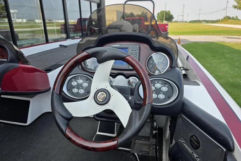 Slide: The Image of 2006 Triton Tr-21X HP DC boat dashboard with steering wheel and control panel. - 8