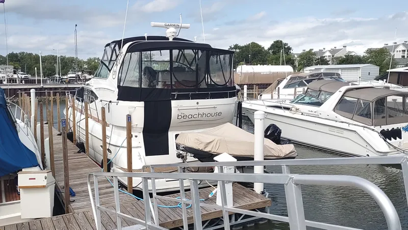 Slide: The Image of 2001 Cruisers Yachts 4450 Express Motoryacht docked at marina, rear view. - 1
