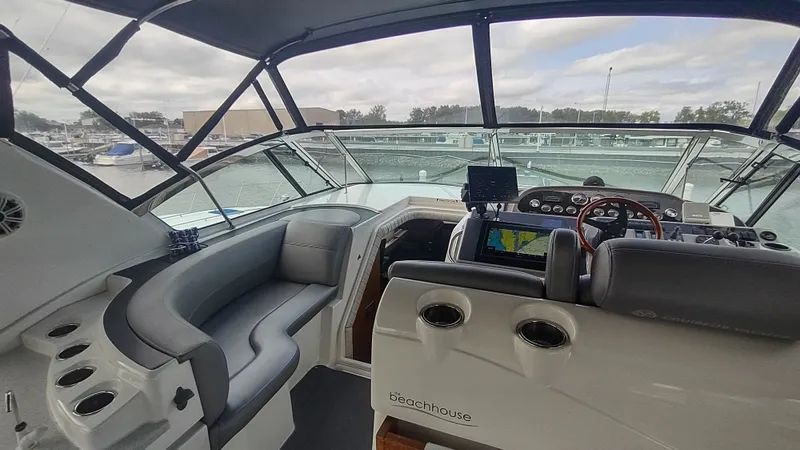 Slide: The Image of 2001 Cruisers Yachts 4450 Express Motoryacht cockpit with navigation equipment and seating. - 12