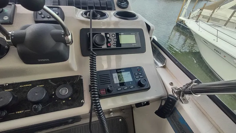 Slide: The Image of Control panel of a 2001 Cruisers Yachts 4450 Express Motoryacht with navigation equipment. - 17