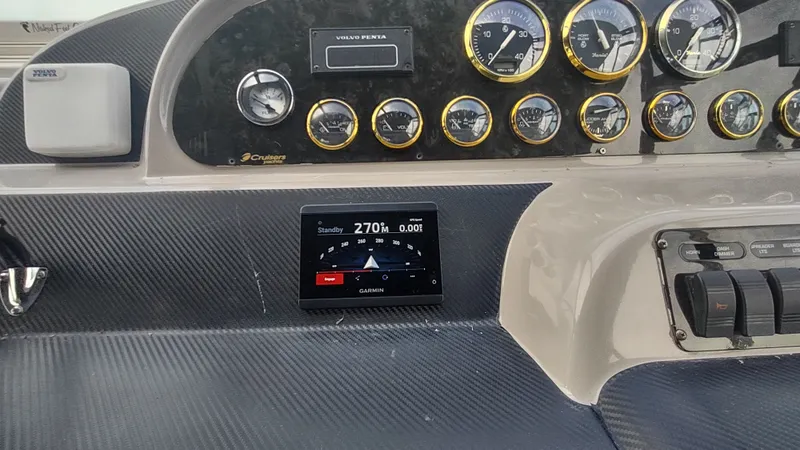 Slide: The Image of Dashboard of 2001 Cruisers Yachts 4450 Express Motoryacht with gauges and Garmin display. - 18