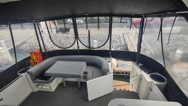 Slide: The Image of 2001 Cruisers Yachts 4450 Express Motoryacht interior with seating and table, docked at marina. - 21