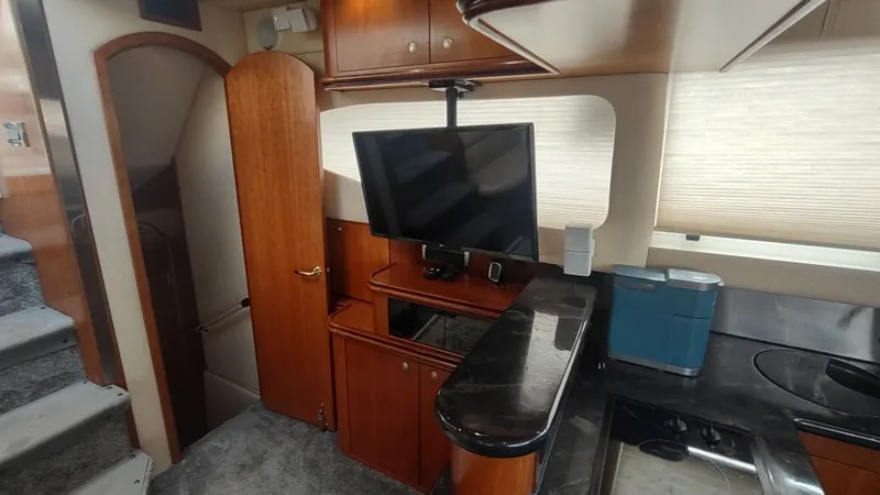 Slide: The Image of Interior of 2001 Cruisers Yachts 4450 Express Motoryacht with TV and kitchenette. - 26