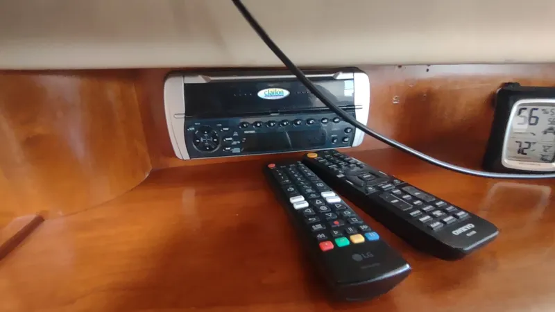 Slide: The Image of 2001 Cruisers Yachts 4450 Express Motoryacht interior with stereo, remotes, and digital thermometer. - 29