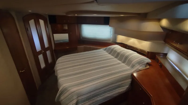 Slide: The Image of Luxurious bedroom interior of 2001 Cruisers Yachts 4450 Express Motoryacht with wood accents. - 31