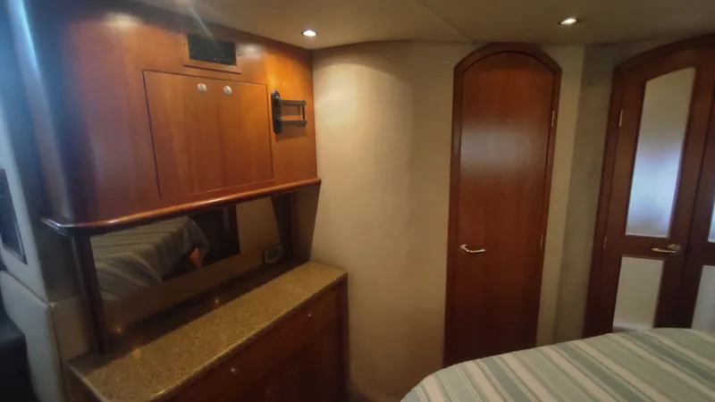 Slide: The Image of Interior of 2001 Cruisers Yachts 4450 Express Motoryacht with wood cabinetry and doors. - 32