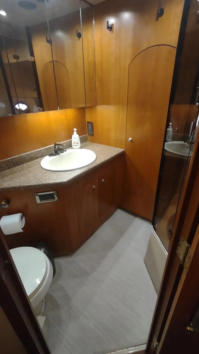 Slide: The Image of Luxurious bathroom in 2001 Cruisers Yachts 4450 Express Motoryacht with wood cabinetry and modern fixtures. - 33