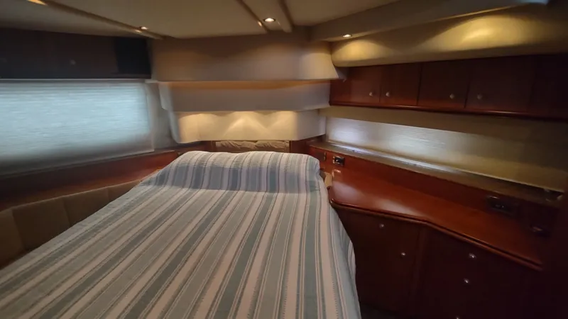 Slide: The Image of Interior of 2001 Cruisers Yachts 4450 Express Motoryacht with bed and wooden cabinetry. - 36