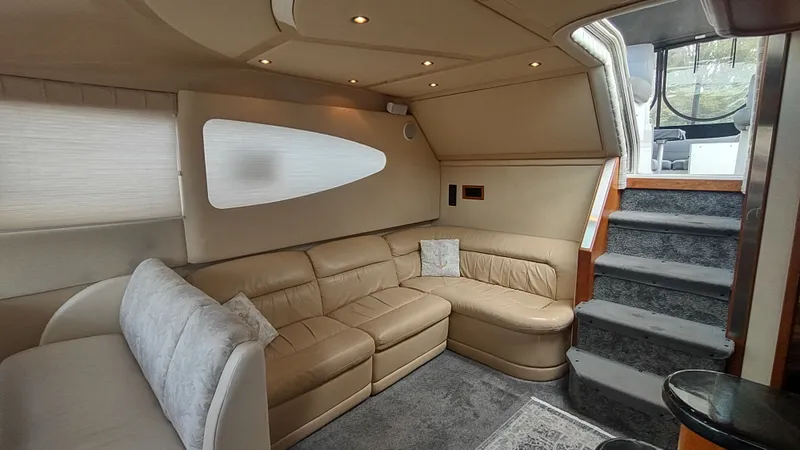 Slide: The Image of Luxurious interior of 2001 Cruisers Yachts 4450 Express Motoryacht with beige leather seating. - 4