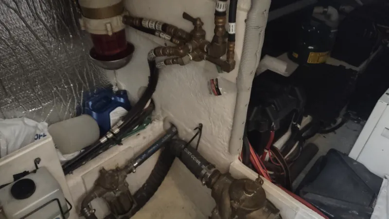 Slide: The Image of Engine room of 2001 Cruisers Yachts 4450 Express Motoryacht with visible plumbing and equipment. - 49