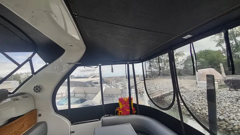 Slide: The Image of Interior view of 2001 Cruisers Yachts 4450 Express Motoryacht, featuring seating and dockside scenery. - 9