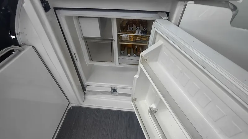 Slide: The Image of Open refrigerator on 2001 Cruisers Yachts 4450 Express Motoryacht, stocked with beverages. - 11