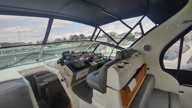 Slide: The Image of 2001 Cruisers Yachts 4450 Express Motoryacht cockpit with modern navigation equipment and comfortable seating. - 13