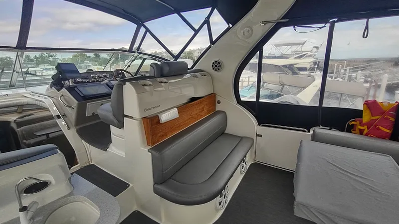 Slide: The Image of 2001 Cruisers Yachts 4450 Express Motoryacht interior with helm and seating area. - 2