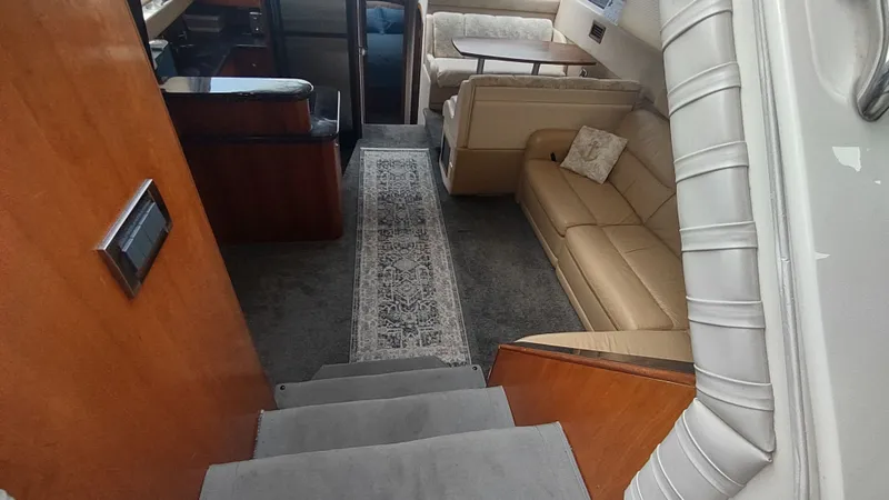 Slide: The Image of Interior of 2001 Cruisers Yachts 4450 Express Motoryacht with beige seating and carpeted floor. - 22