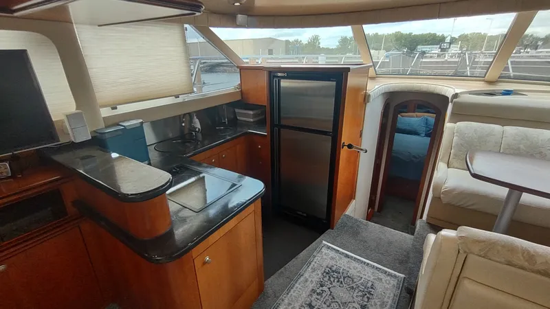 Slide: The Image of Interior of 2001 Cruisers Yachts 4450 Express Motoryacht with kitchen and seating area. - 24