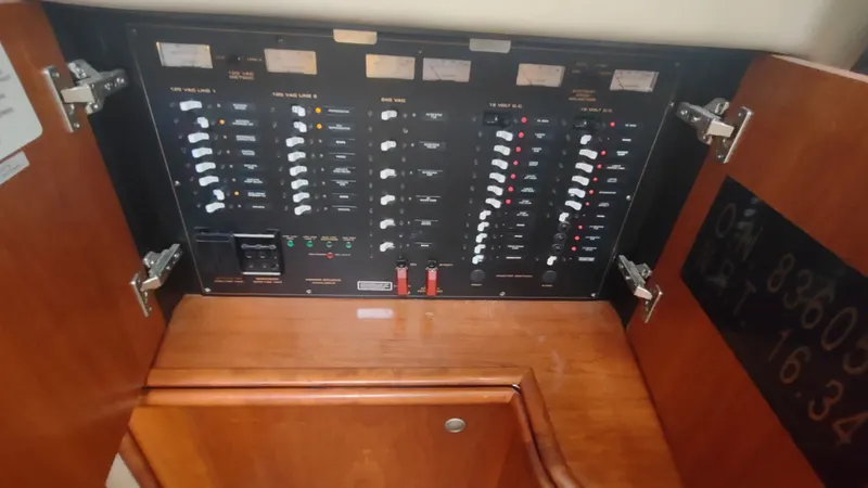 Slide: The Image of Electrical panel inside 2001 Cruisers Yachts 4450 Express Motoryacht, featuring switches and meters. - 27